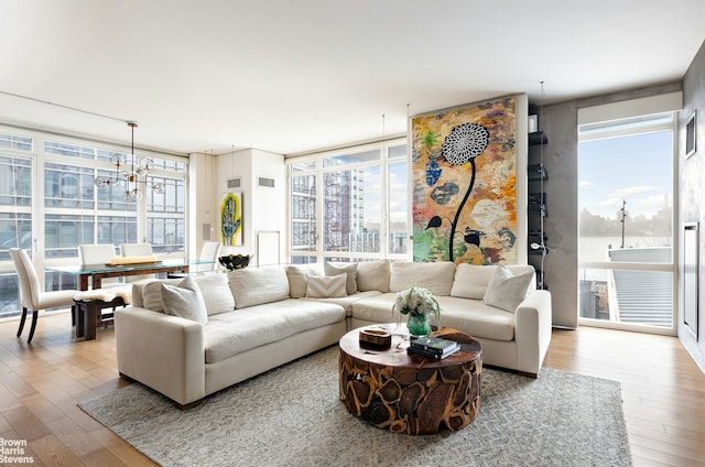 living area with floor to ceiling windows, wood finished floors, and a chandelier
