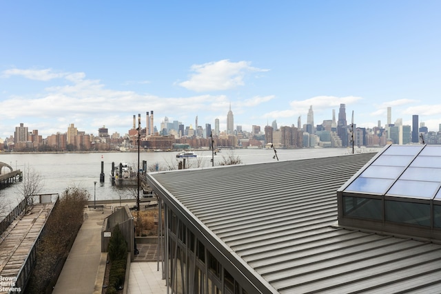 dock featuring a skyline view and a water view