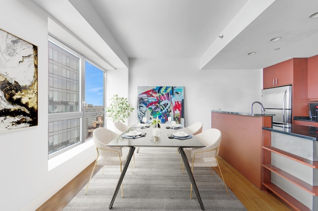 dining space featuring light wood-style flooring