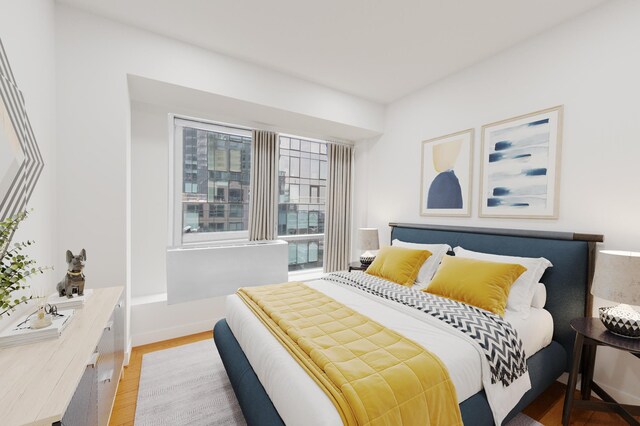 440 Kent Ave Unit 20-C, New York City, NY 11249 - bedroom featuring light wood-style floors and baseboards