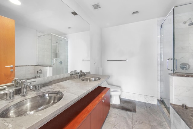 full bath with a stall shower, marble finish floor, and a sink
