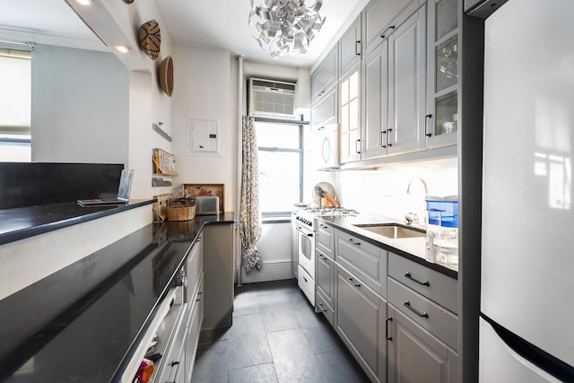 834 Riverside Dr Unit 2-E, New York City, NY 10032 - kitchen with freestanding refrigerator, high end stainless steel range, a sink, glass insert cabinets, and dark countertops