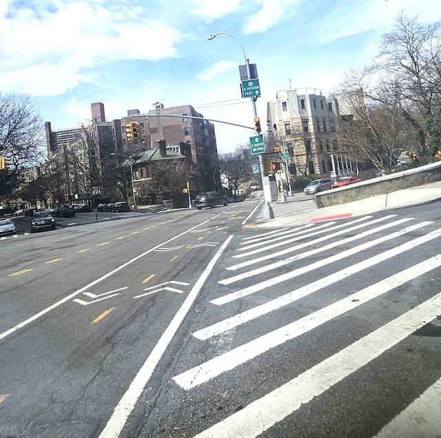 834 Riverside Dr Unit 2-E, New York City, NY 10032 - view of asphalt street featuring street lights, sidewalks, traffic lights, and curbs