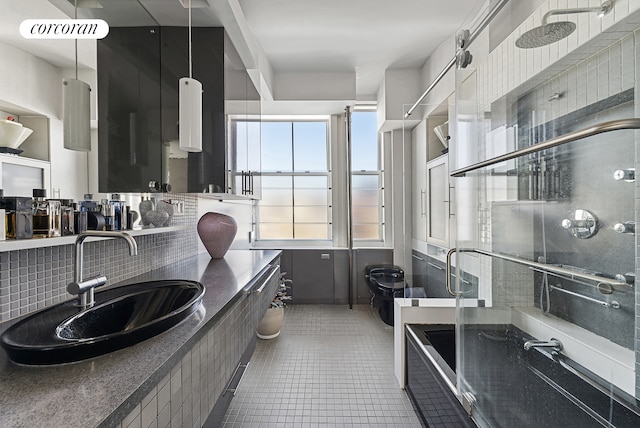 45 Lispenard St Unit 8E, New York City, NY 10013 - kitchen featuring a sink, tasteful backsplash, tile patterned flooring, and dark countertops