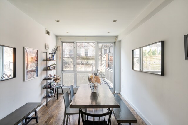 307 Cooper St Unit 1B, New York City, NY 11237 - dining area featuring dark wood-style flooring and plenty of natural light