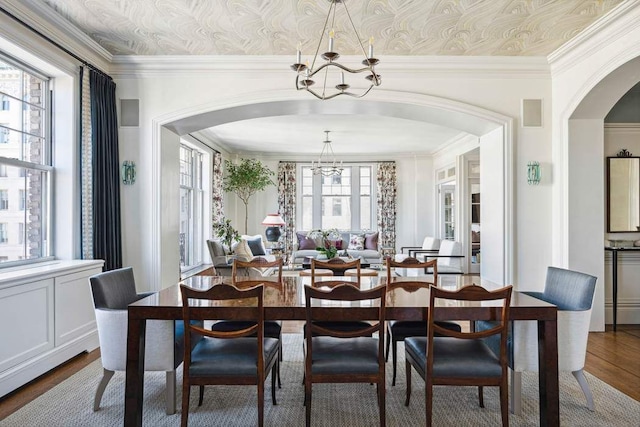 375 W End Ave Unit 9Ab, New York City, NY 10024 - dining area featuring a chandelier, arched walkways, dark wood-style flooring, and crown molding