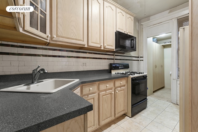 kitchen with backsplash, dark countertops, light brown cabinets, a sink, and black appliances