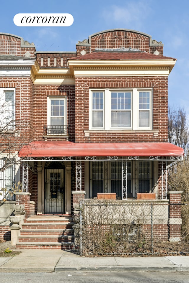 view of front of property featuring brick siding and covered porch