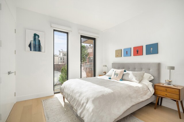 269 4th Ave Unit 403, New York City, NY 11215 - bedroom with access to outside, light wood finished floors, and baseboards