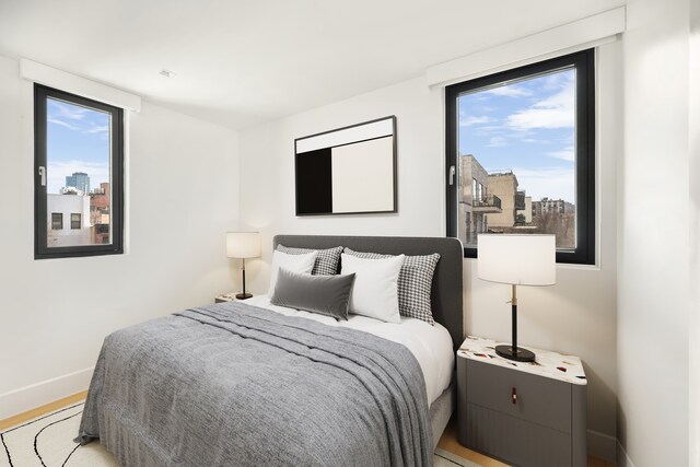 269 4th Ave Unit 403, New York City, NY 11215 - bedroom featuring baseboards, light wood-style flooring, and a city view