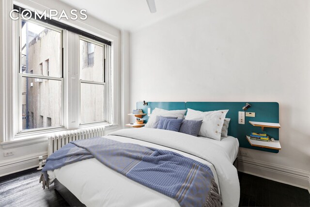 366 Broadway Unit 5C, New York City, NY 10013 - bedroom featuring radiator heating unit, wood finished floors, baseboards, and a ceiling fan