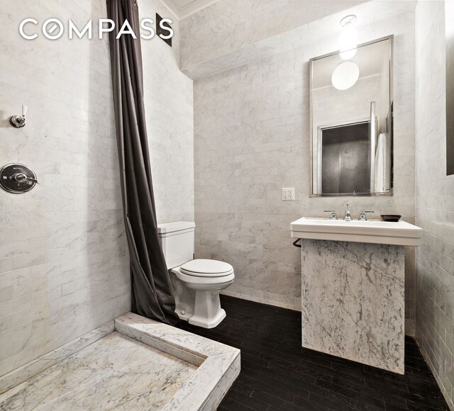 366 Broadway Unit 5C, New York City, NY 10013 - bathroom featuring toilet, hardwood / wood-style flooring, a tile shower, and vanity