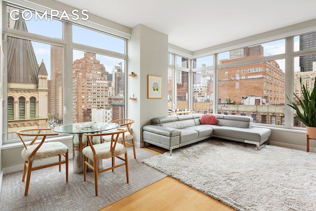 sunroom featuring plenty of natural light and a view of city