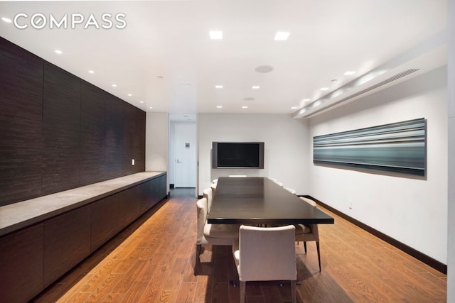 dining room with wood finished floors, baseboards, and recessed lighting