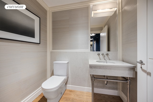 71 Laight St Unit 3B, New York City, NY 10013 - bathroom featuring toilet, a sink, crown molding, and wood finished floors