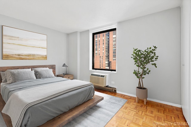 bedroom with baseboards and an AC wall unit