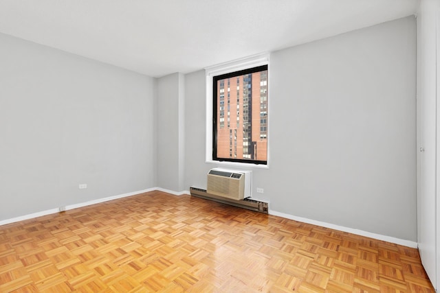 empty room featuring baseboards, an AC wall unit, and baseboard heating