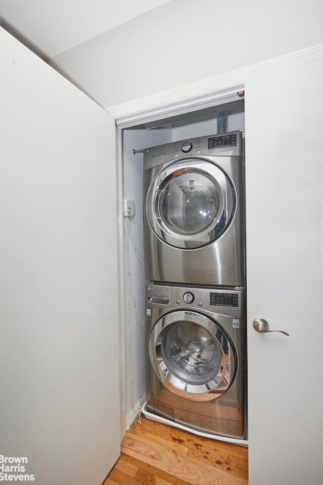 3750 Hudson Manor Ter Unit 6De, New York City, NY 10463 - laundry area featuring estacked washer and dryer and wood finished floors