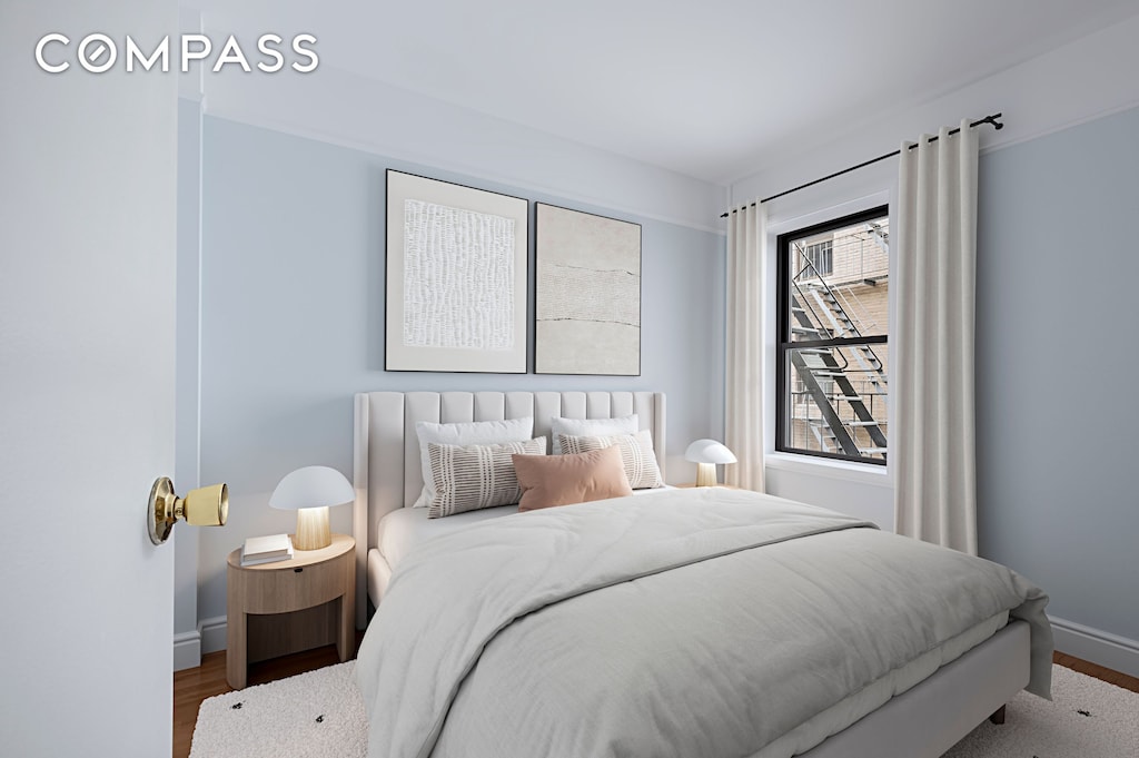 87 Barrow St Unit 5E, New York City, NY 10014 - bedroom featuring baseboards and wood finished floors