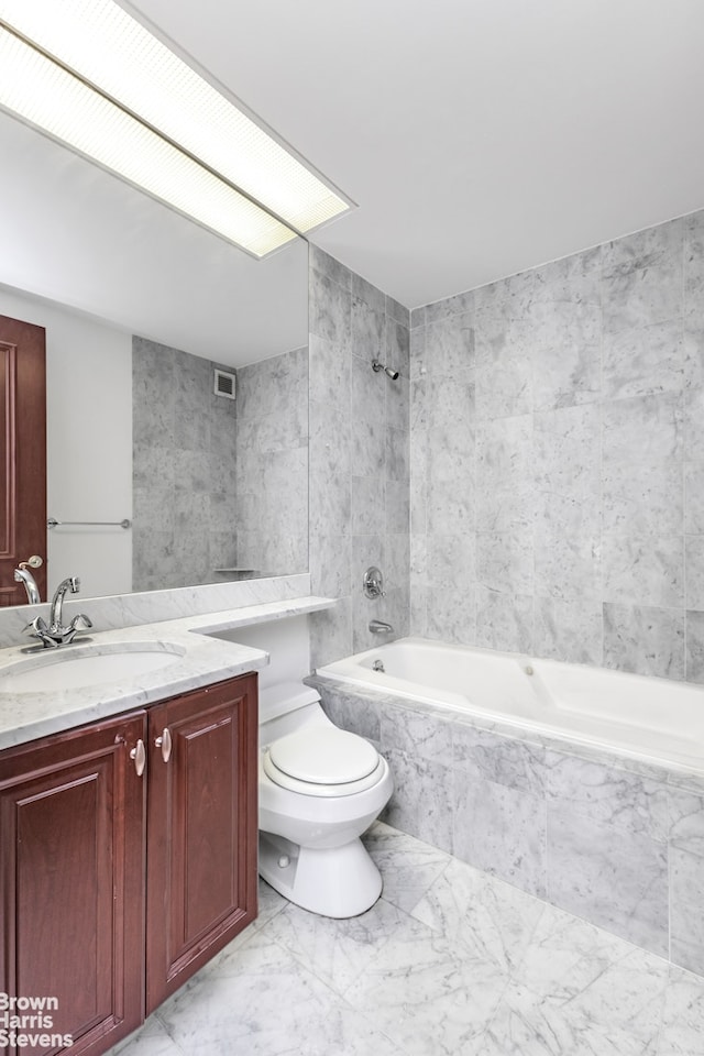 300 E 85th St Unit 2202, New York City, NY 10028 - bathroom featuring marble finish flooring, tiled shower / bath combo, toilet, vanity, and tile walls