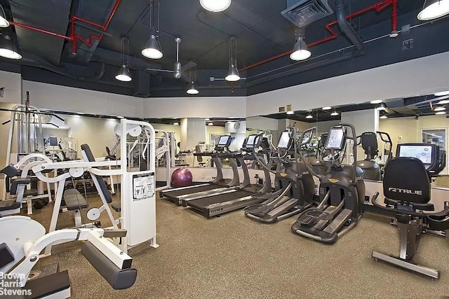 workout area with a high ceiling