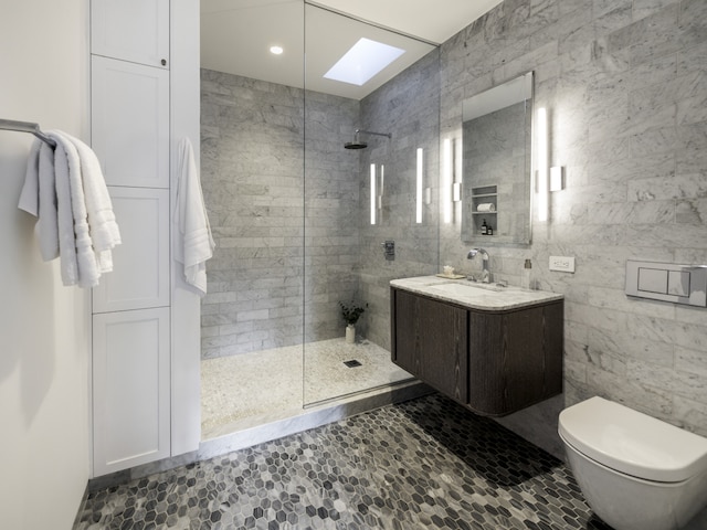bathroom with vanity, a walk in shower, a skylight, and toilet