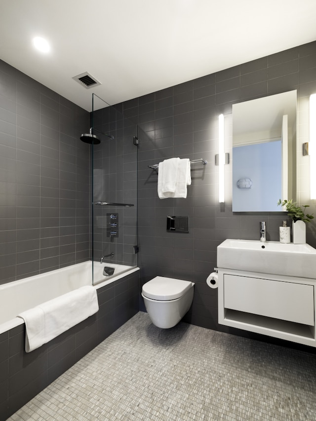 366 Broadway Ph Ph, New York City, NY 10013 - bathroom with vanity, tiled shower / bath, tile walls, and toilet