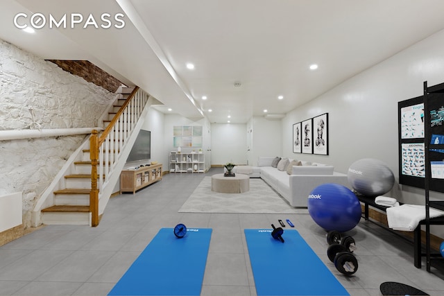 exercise area featuring tile patterned flooring and recessed lighting