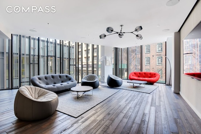 90 Furman St Unit N510, New York City, NY 11201 - living area with a chandelier, wood finished floors, plenty of natural light, and expansive windows