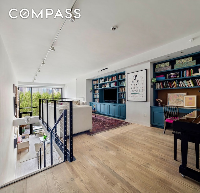 90 Furman St Unit N510, New York City, NY 11201 - living room featuring track lighting, wood finished floors, and built in shelves