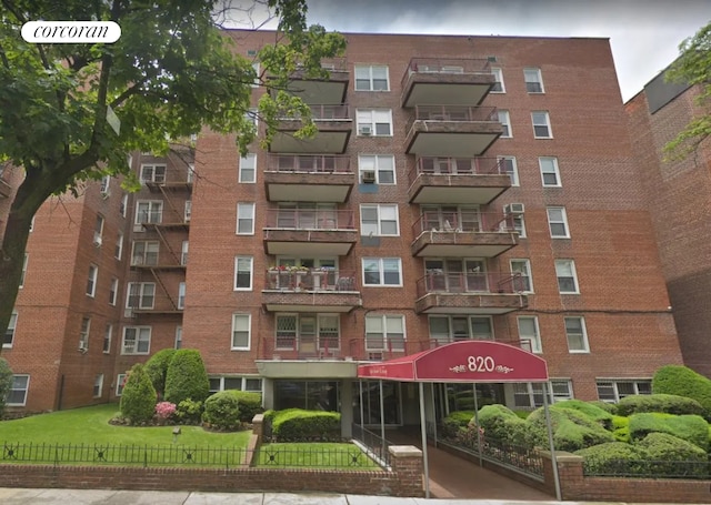 view of apartment building / complex featuring fence