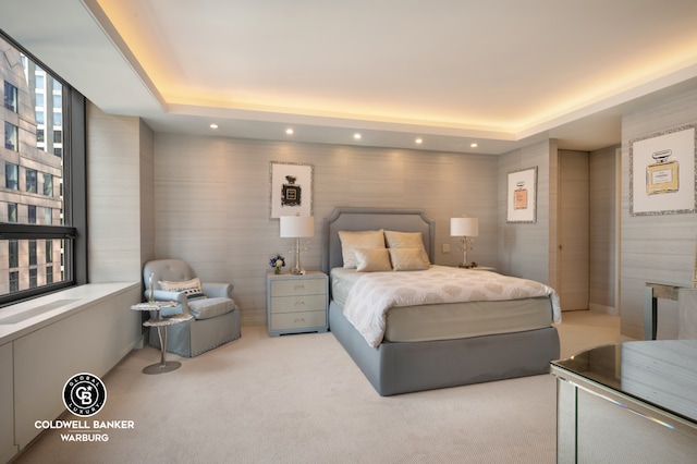 bedroom with carpet, a tray ceiling, and recessed lighting