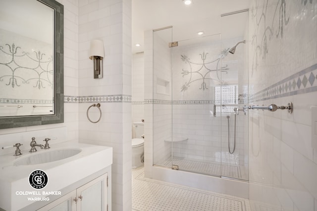 bathroom featuring tile walls, a shower stall, vanity, toilet, and recessed lighting