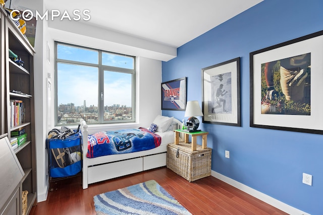 bedroom featuring dark wood-style floors and baseboards