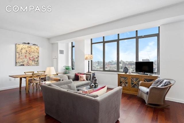 living area featuring baseboards and dark wood finished floors