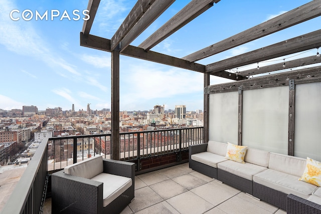 balcony with an outdoor hangout area, a city view, and a pergola