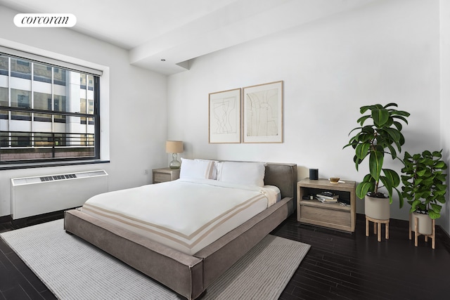 bedroom featuring radiator heating unit, dark wood-style floors, and visible vents