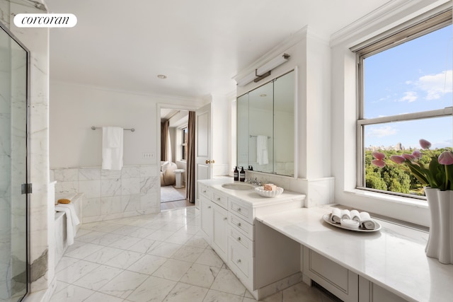 bathroom featuring ornamental molding, a marble finish shower, vanity, marble look tiles, and a wainscoted wall