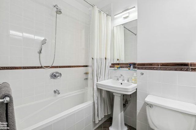 full bath featuring shower / bath combination with curtain, toilet, and a sink