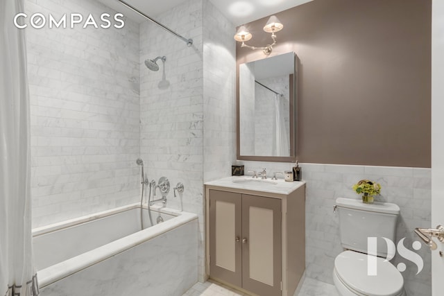 135 E 79th St Unit 8E, New York City, NY 10075 - bathroom with vanity, tile walls, toilet, shower / washtub combination, and wainscoting