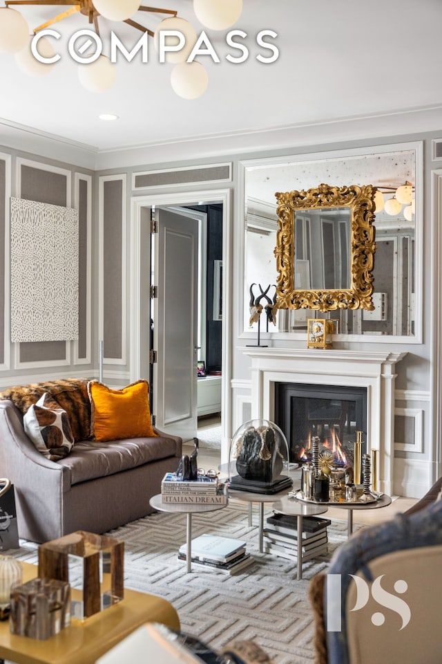 135 E 79th St Unit 8E, New York City, NY 10075 - living area with a decorative wall, ornamental molding, and a glass covered fireplace