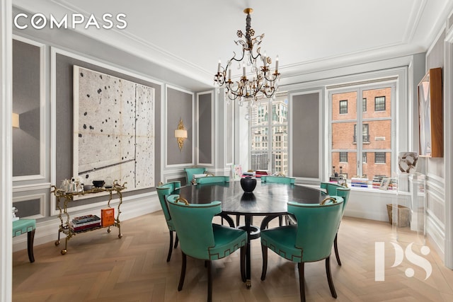 135 E 79th St Unit 8E, New York City, NY 10075 - dining space featuring a decorative wall, a chandelier, ornamental molding, and wainscoting