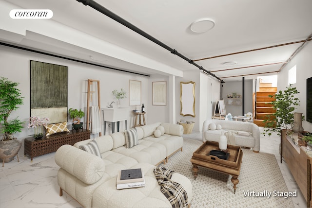 living area featuring visible vents and marble finish floor