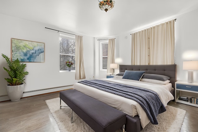 867 Riverside Dr, New York City, NY 10032 - bedroom with wood finished floors and a baseboard radiator