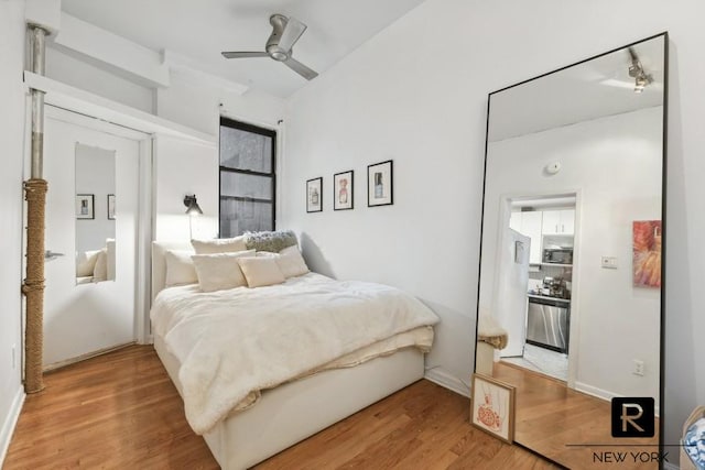 64 Macdougal St Unit 12, New York City, NY 10012 - bedroom with light wood-style floors, ceiling fan, and baseboards