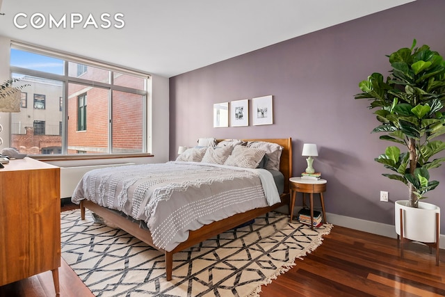 bedroom with wood finished floors and baseboards