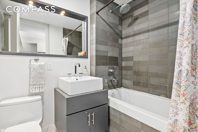 full bath with tiled shower / bath, vanity, and toilet