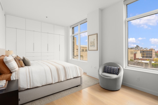 bedroom with baseboards and wood finished floors