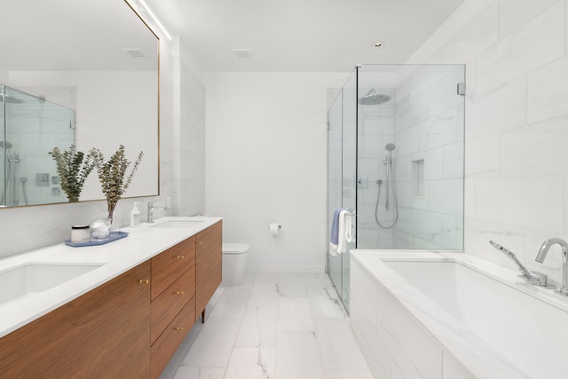 full bath with a garden tub, a shower stall, a sink, toilet, and marble finish floor