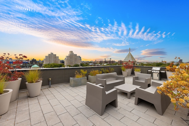 view of patio with an outdoor kitchen, a view of city, and an outdoor hangout area